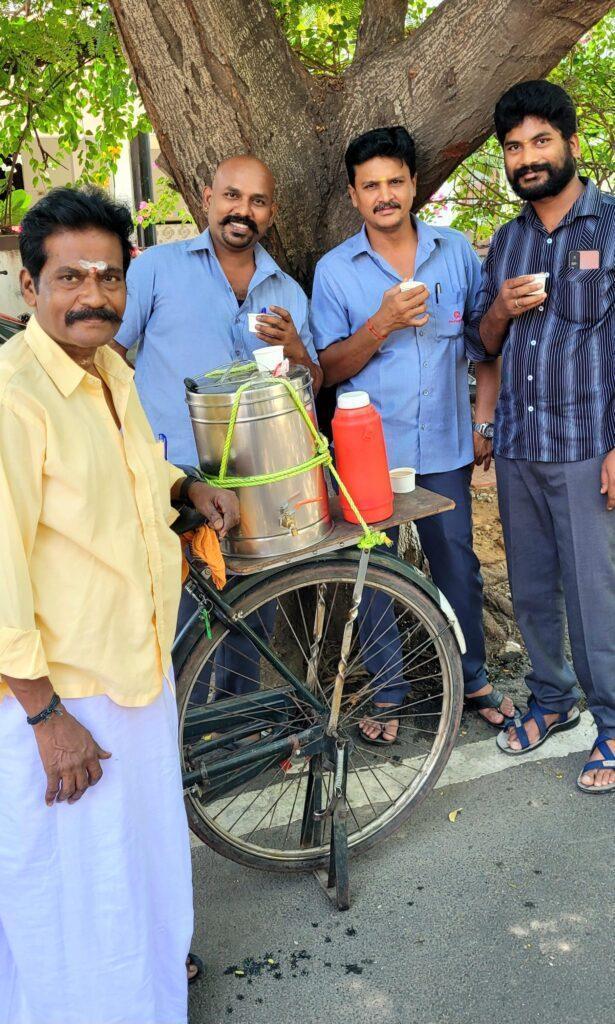 trois buveurs de thé autour d'un chawallah, vendeur de thé dans les rues de Chennai